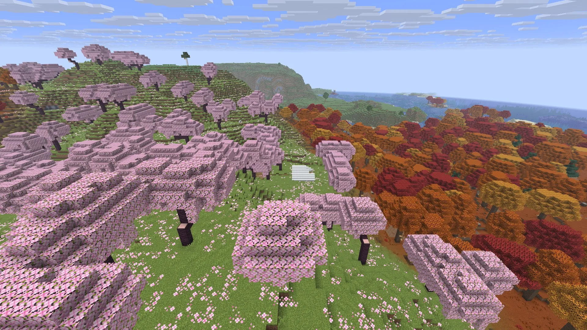 Small white tent in a grassy clearing among pink cherry trees, with red and orange dappled forest to the right and the sea in the distance. In-game screenshot, Java 26.3.