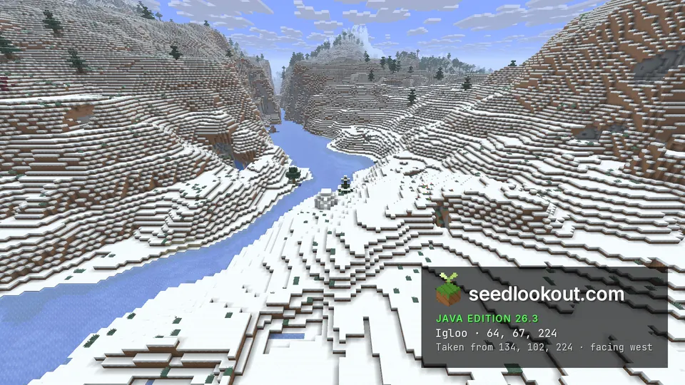 Small white igloo on a snowy bank beside a frozen river winding between steep snowy hills
