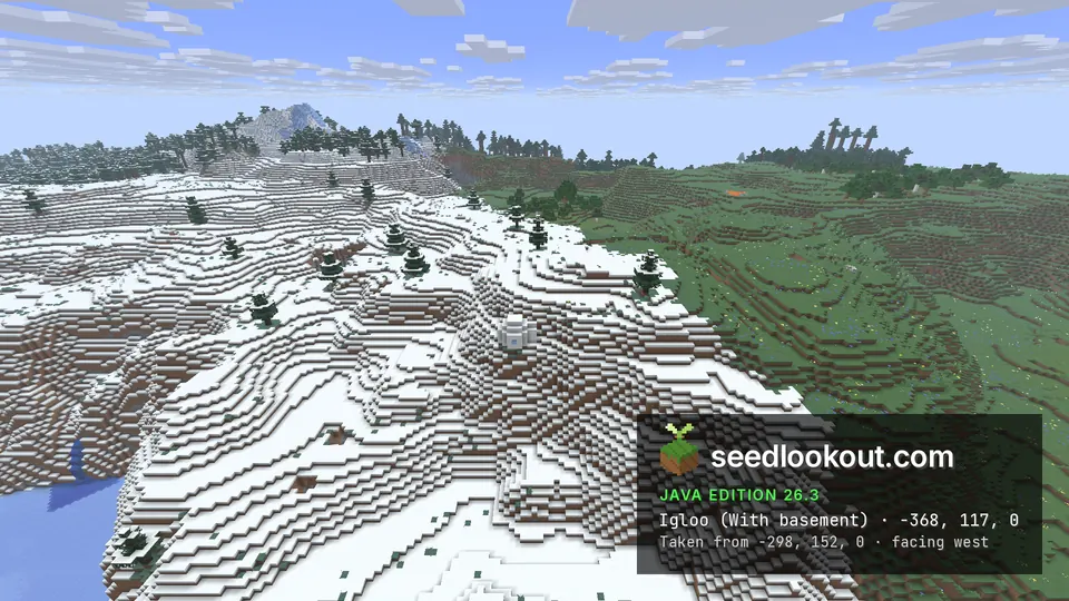 Small white igloo on terraced snowy slopes, green grassland to the right and a snowy peak behind