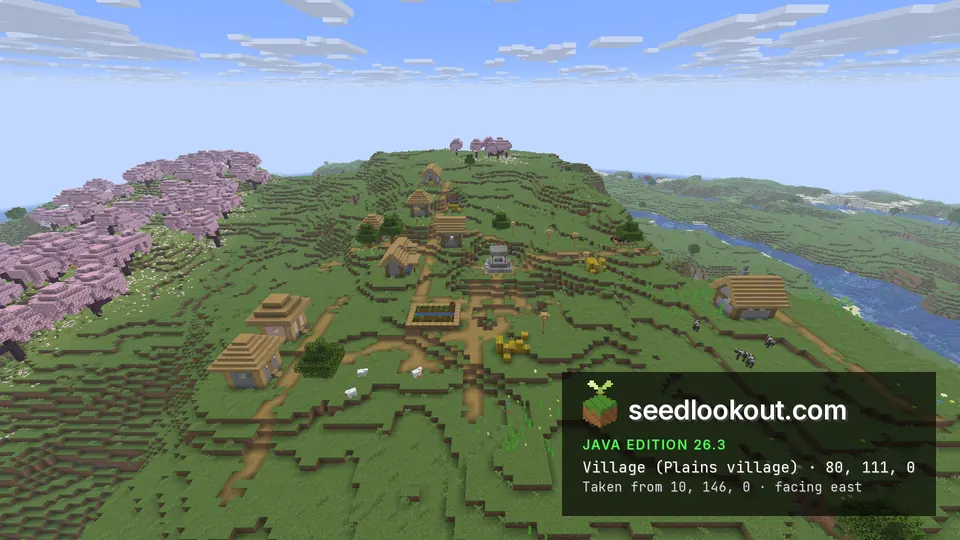 Village on a green hilltop with pink cherry trees on the left and a river valley on the right