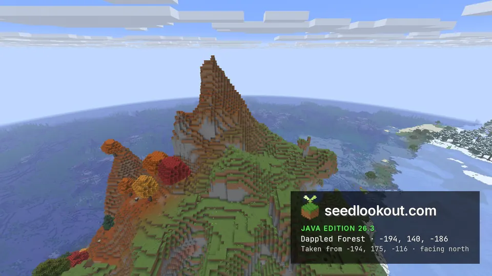 Steep pointed peak with red, orange and yellow trees on orange ground on its upper slopes, sea below