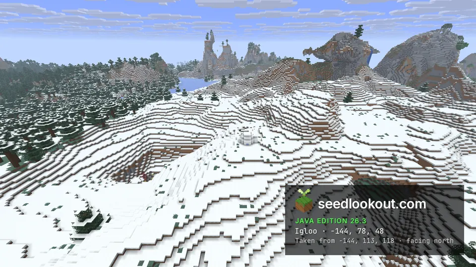 Small white igloo on rolling snowy hills beside a rocky hollow, with spruce forest and peaks behind